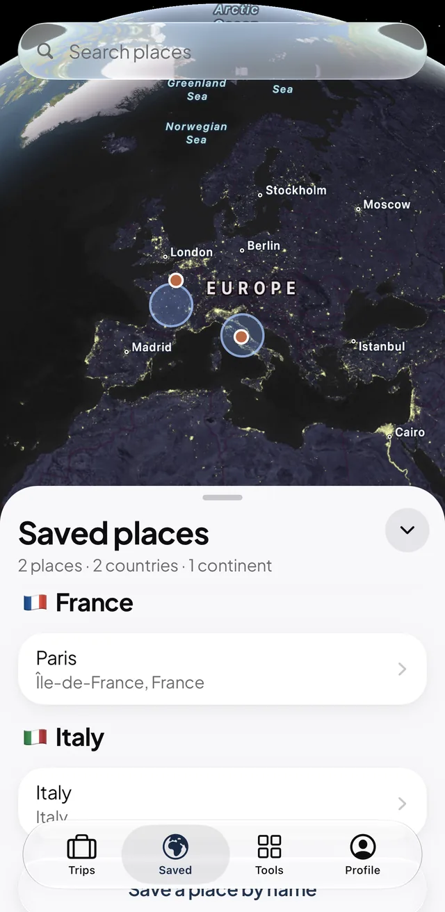 Mapia Saved tab on a globe of Europe at night with two saved places, Paris and Rome.